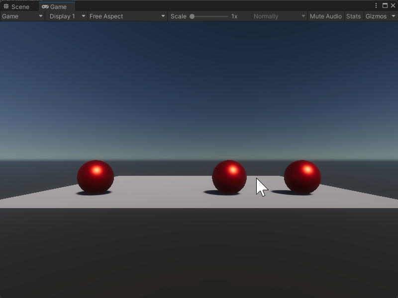 An image of the Game view. Three red spheres sit on a plane. The middle sphere moves towards the sphere on the right and the mouse cursor.